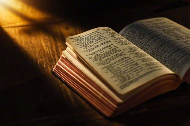 Close up of open Bible on table